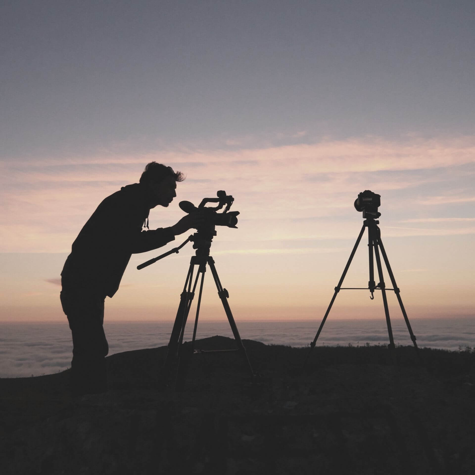Video Marketing Man with video camera at dusk