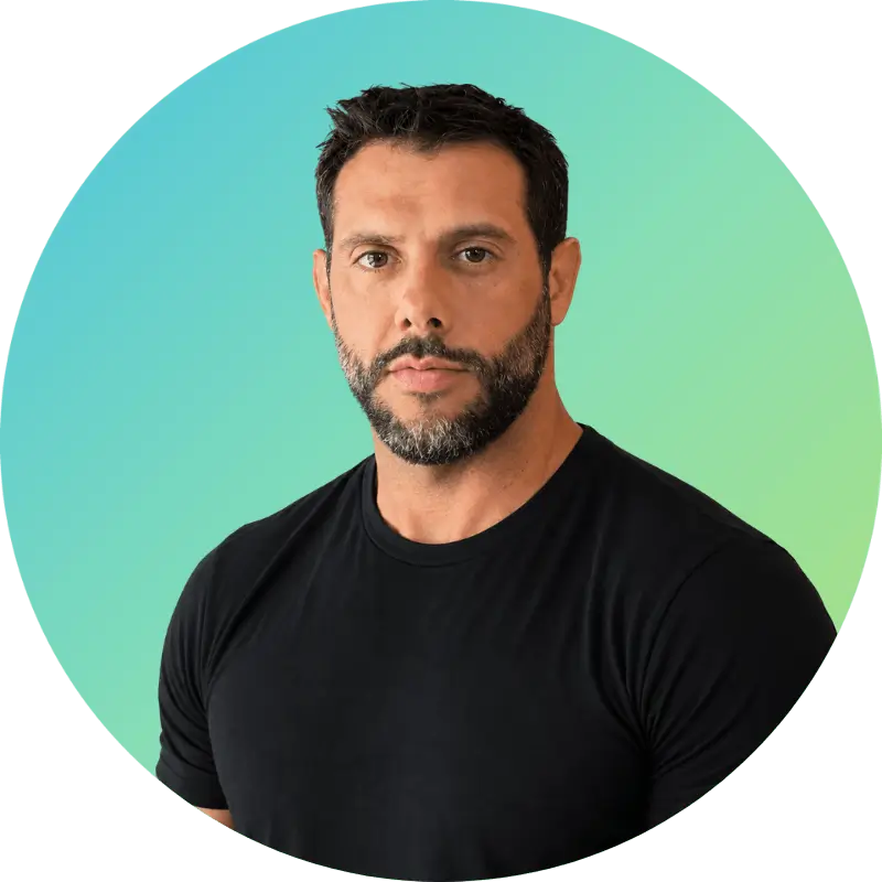 Employee Bio: Carl, a man with short dark hair and beard, stands in a black t-shirt before a blue-green gradient background.